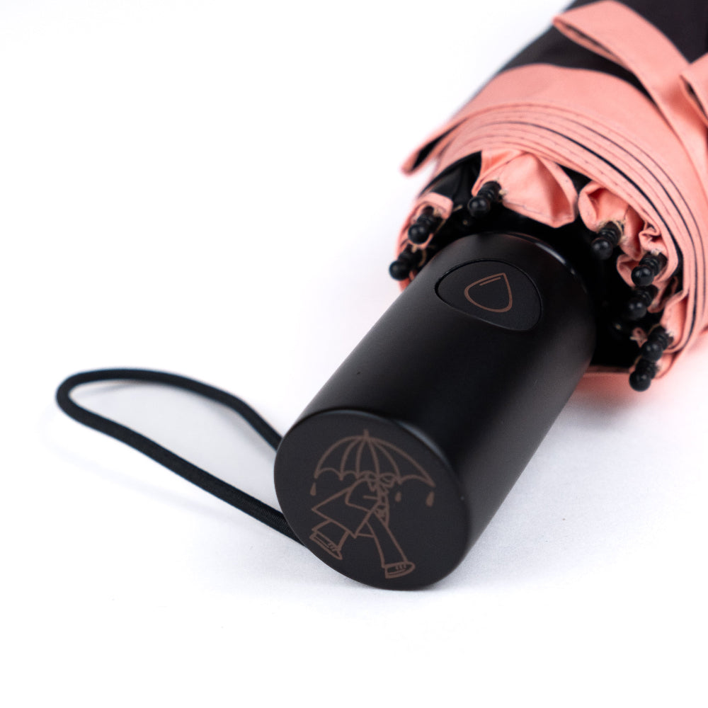 Black umbrella with pink canopy on a white background