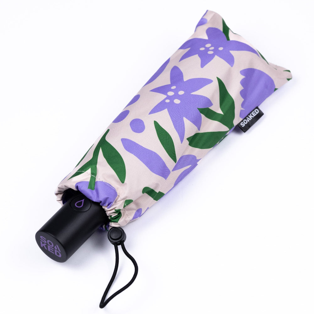 Foldable umbrella with purple floral pattern on a white background