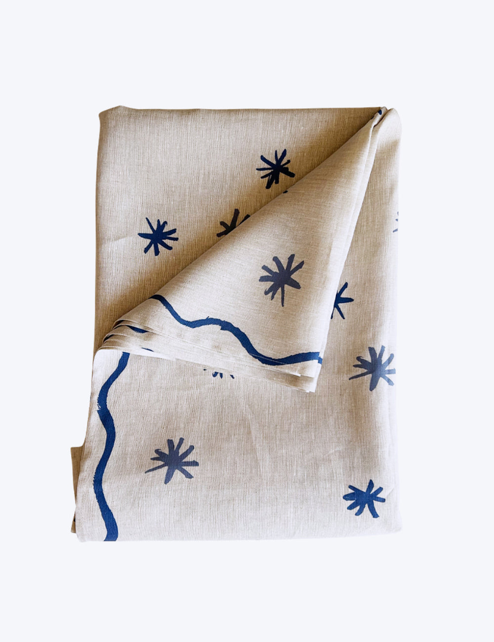 Linen tablecloth with blue star patterns on a white background
