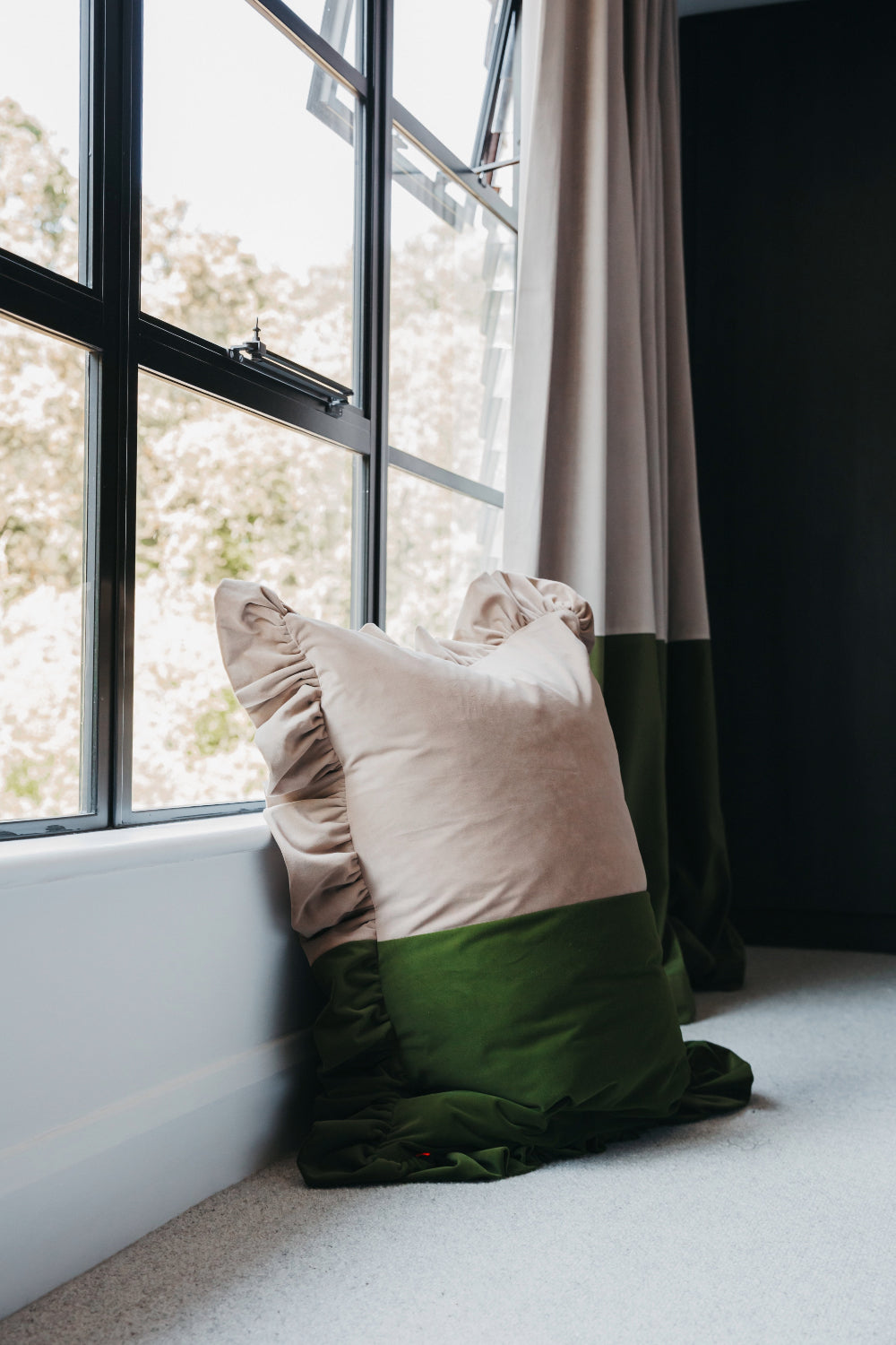 Close-up of the Stone and Forest Green velvet ruffled cushion