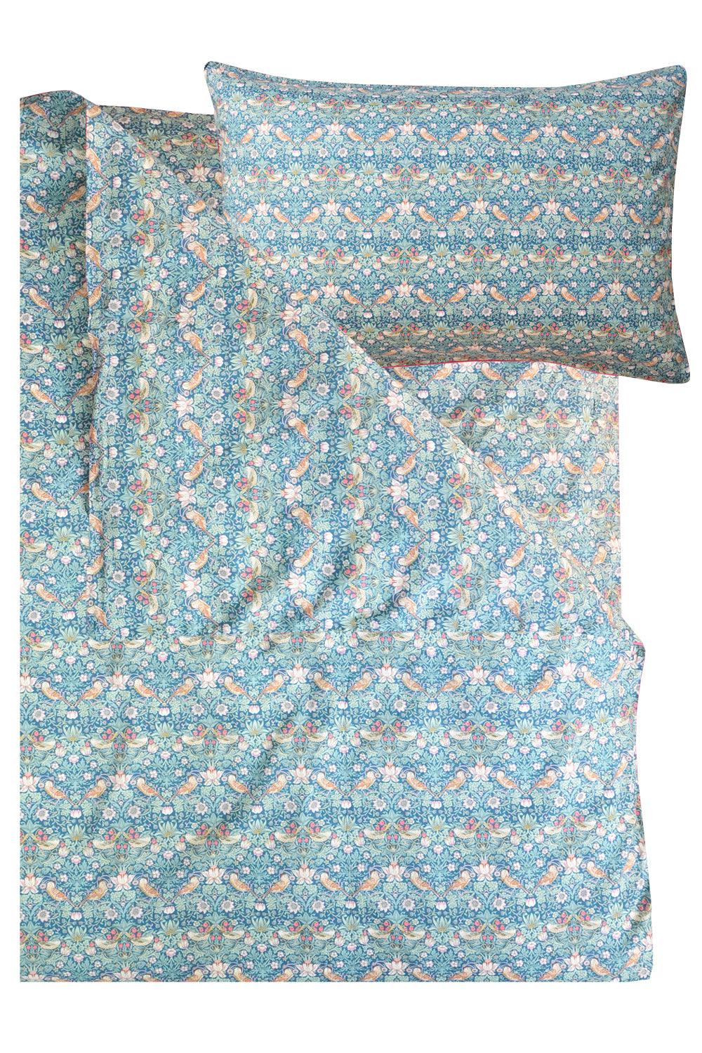 Floral patterned bed sheet set with matching pillowcase on a white background