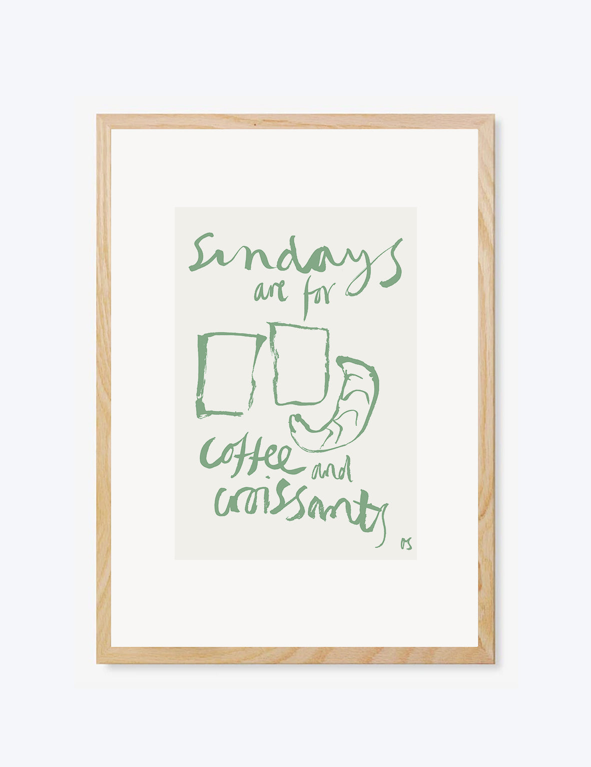Framed print with green text 'Sundays are for coffee and croissants' on a white background