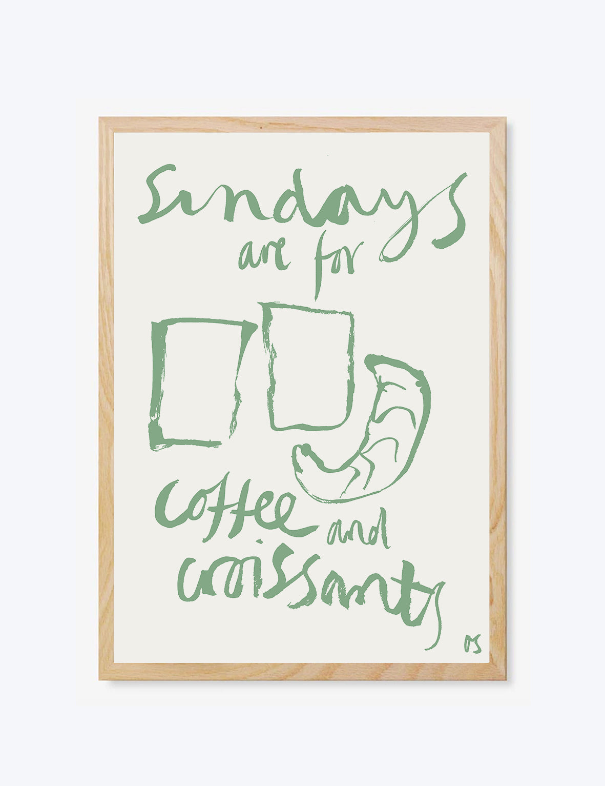 Framed artwork with green text 'Sundays are for coffee and croissants' on a white background