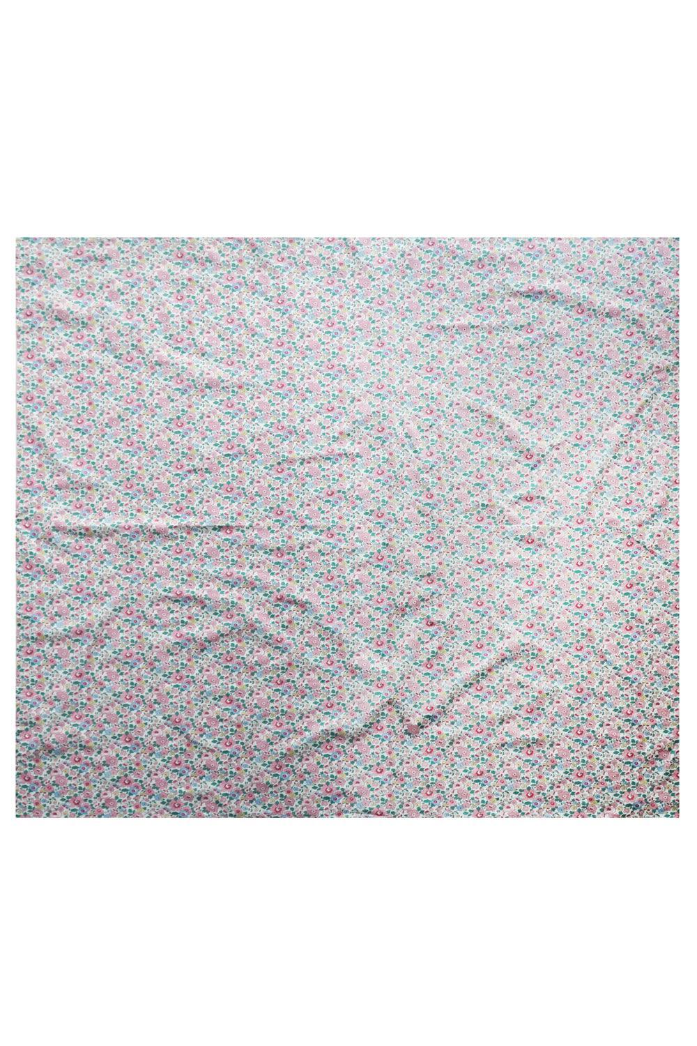 Floral patterned fabric tablecloth Liberty fabric on a white background