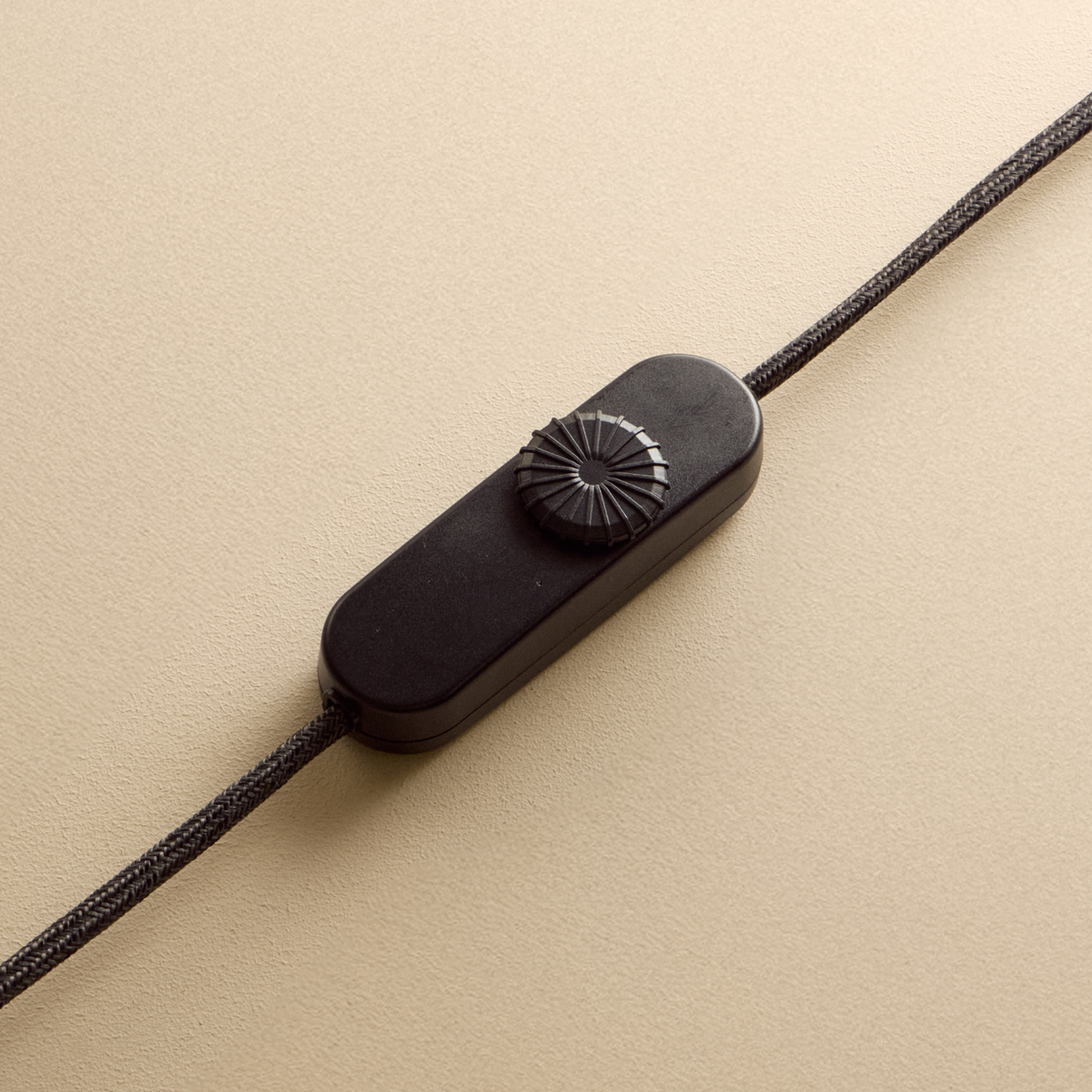 Close-up of the Tala Knuckle oak lamp and brass base switch