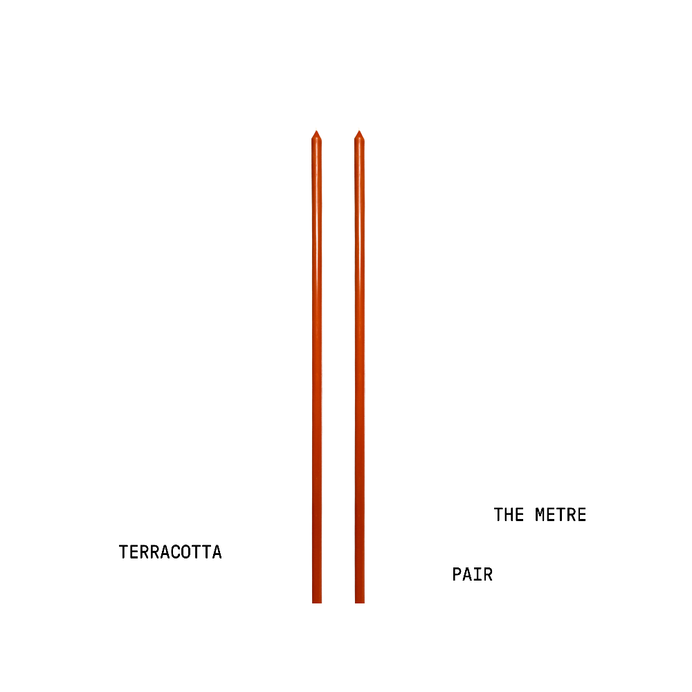 Two terracotta candles with text indicating 'Terracotta' and 'The Metre Pair' on a white background.