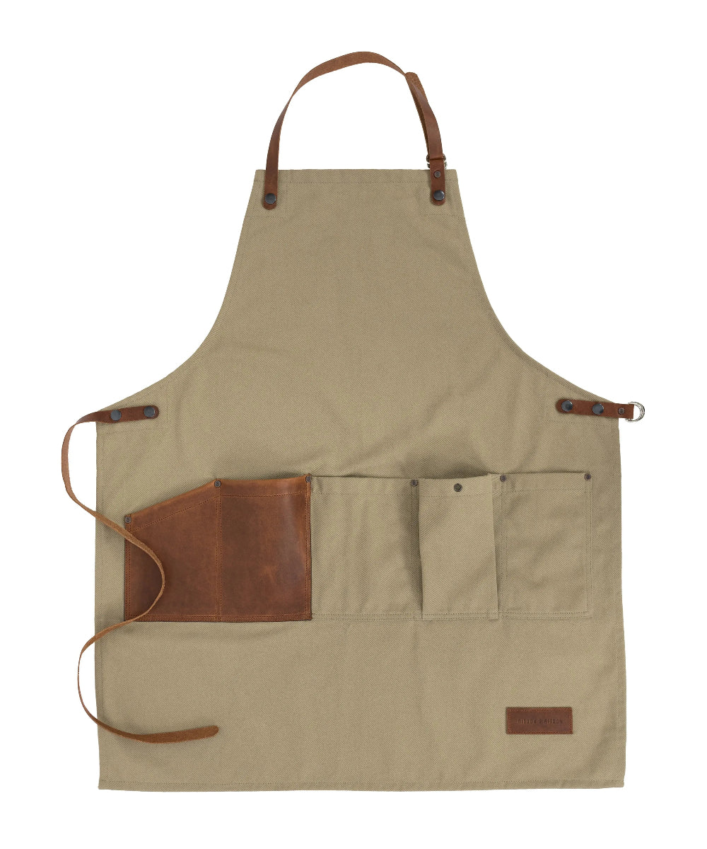 Beige apron with brown leather accents on a white background