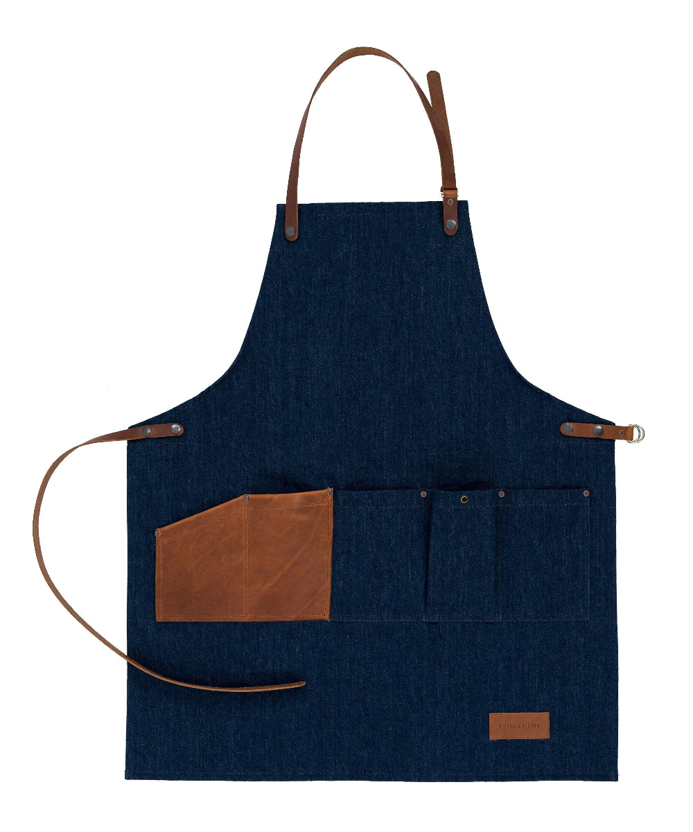 Blue apron with brown leather accents on a white background