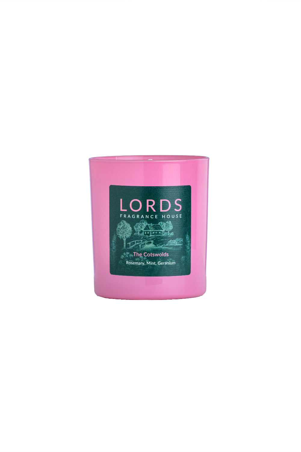 Pink candle called the cotswolds with a green label on a white background