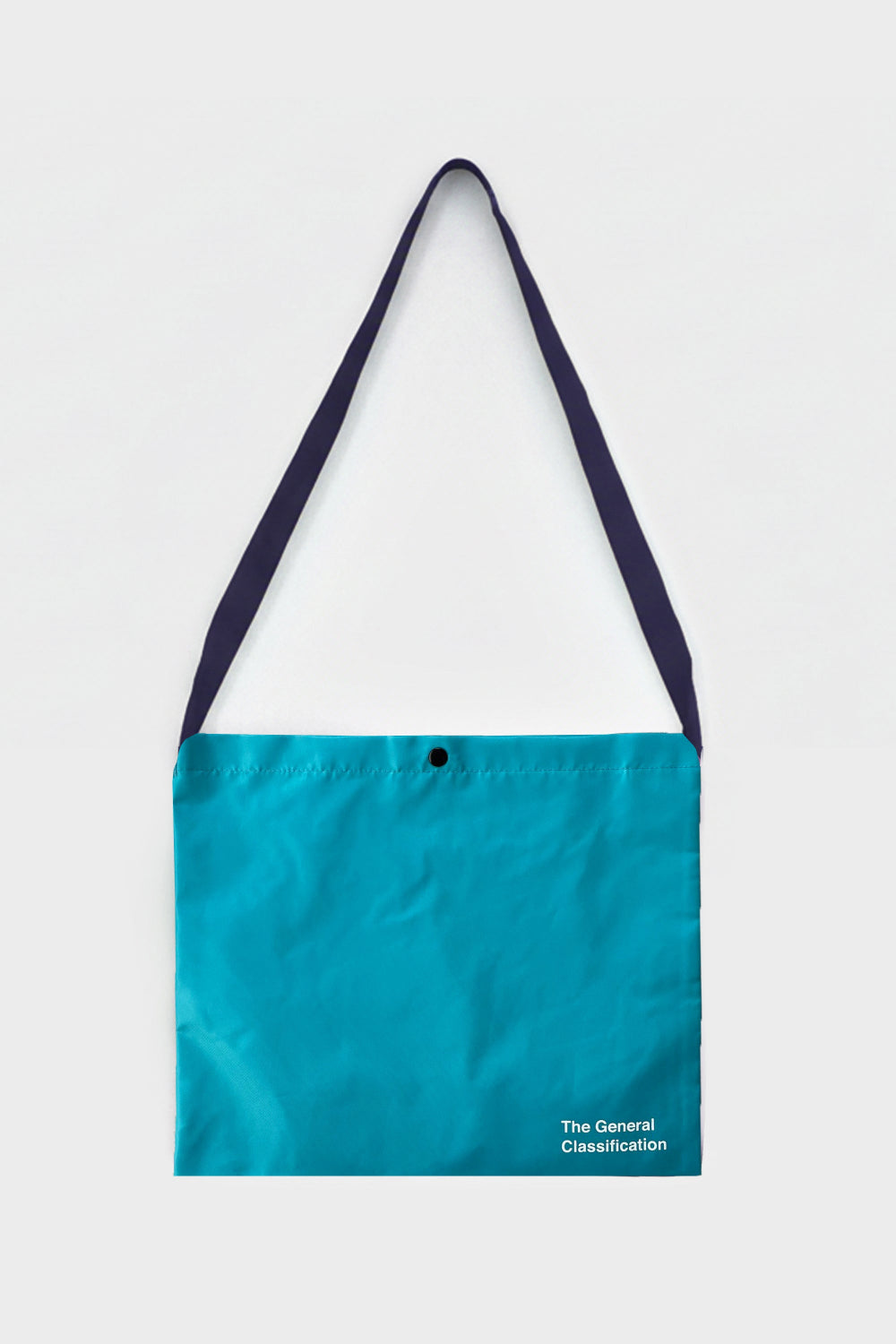 A turquoise blue tote bag with dark navy straps and a small white text logo in the bottom right corner, displayed against a light gray background.