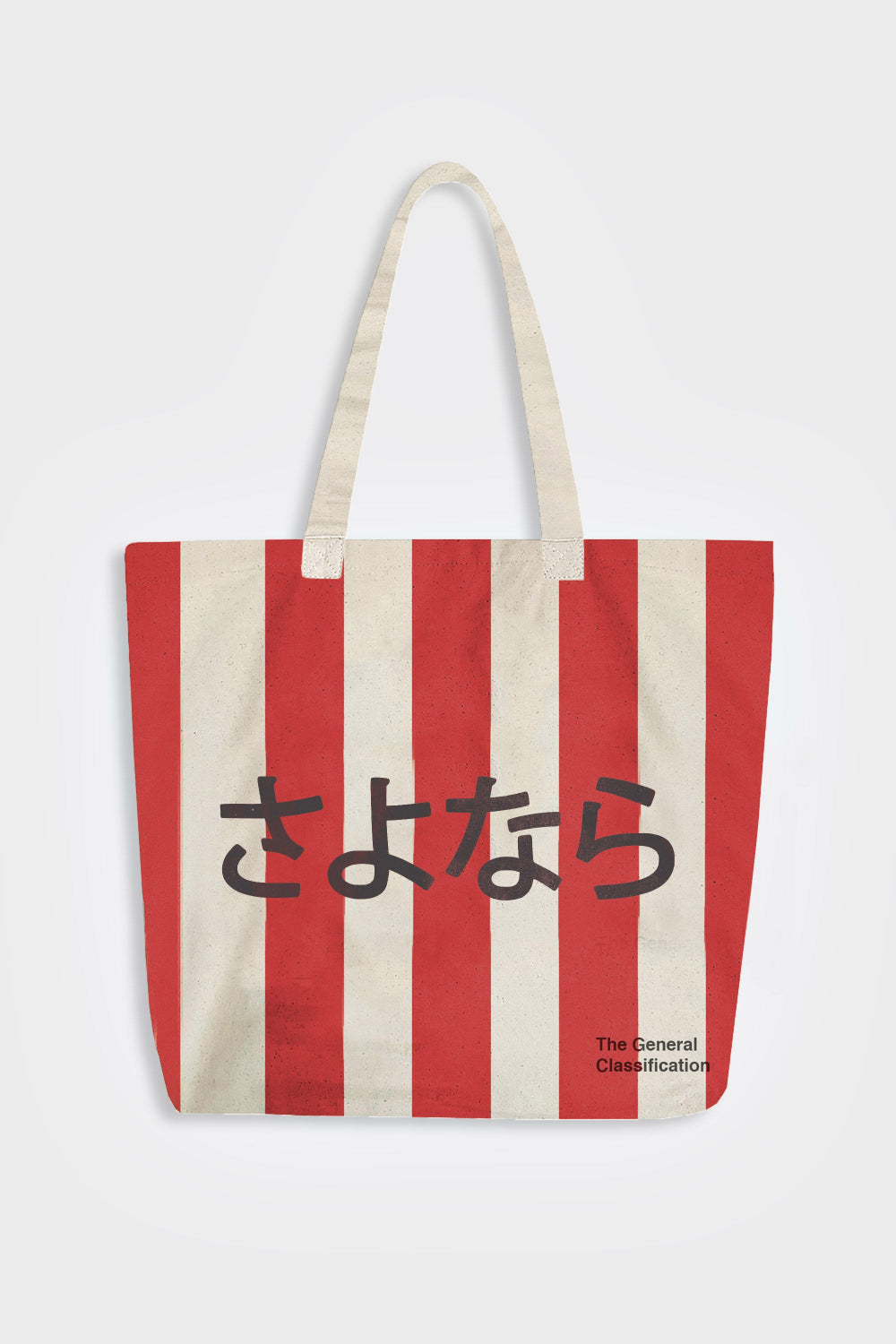 A canvas tote bag with vertical red and off-white stripes, featuring the Japanese text in black across the center and 'The General Classification' printed in the bottom right corner. The bag has two off-white shoulder straps and is photographed against a light gray background.