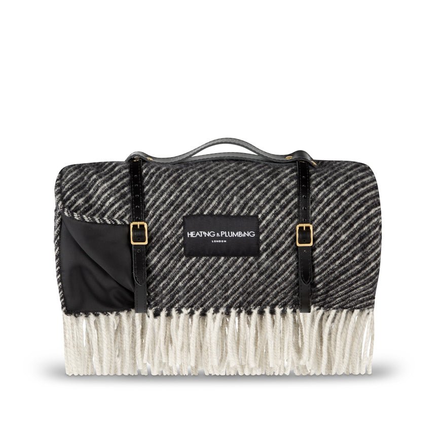 Black and white patterned blanket with a visible brand label on a white background