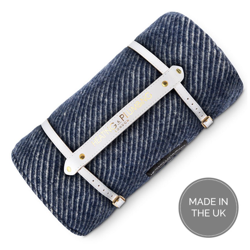 Blue herringbone blanket with a white metal frame on a white background, featuring 'Made in the UK' label.