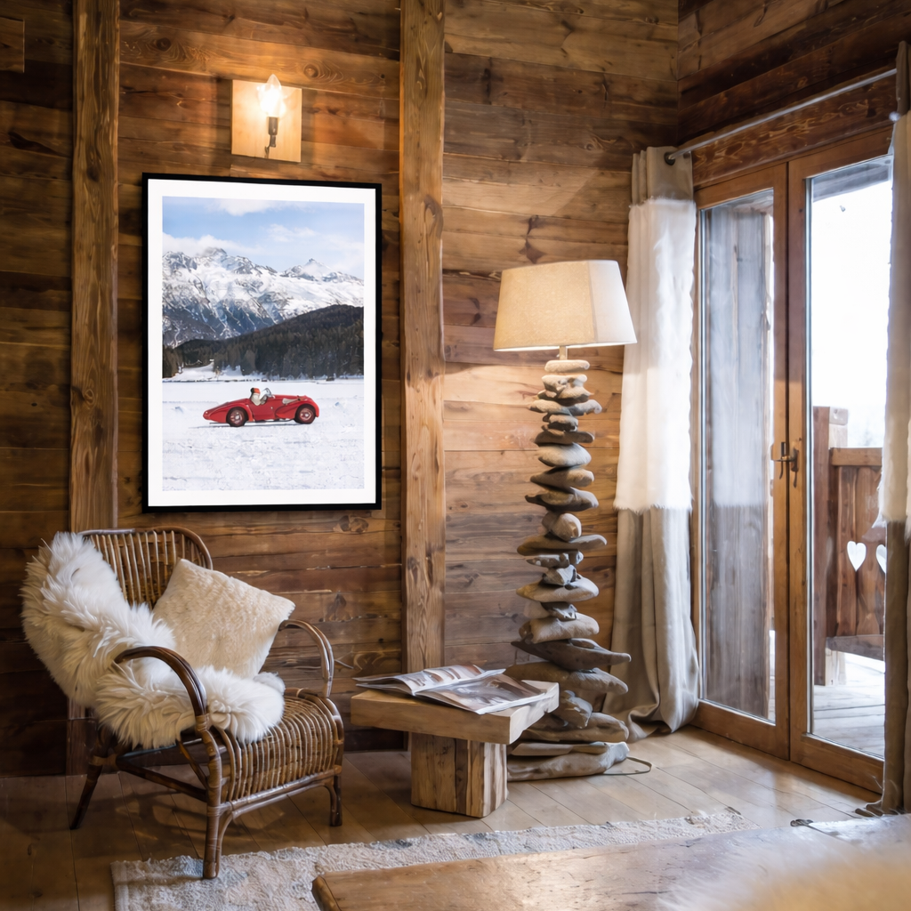 Cozy living room with wooden walls, a chair with a white fur throw, and a mountain-themed print on the wall.