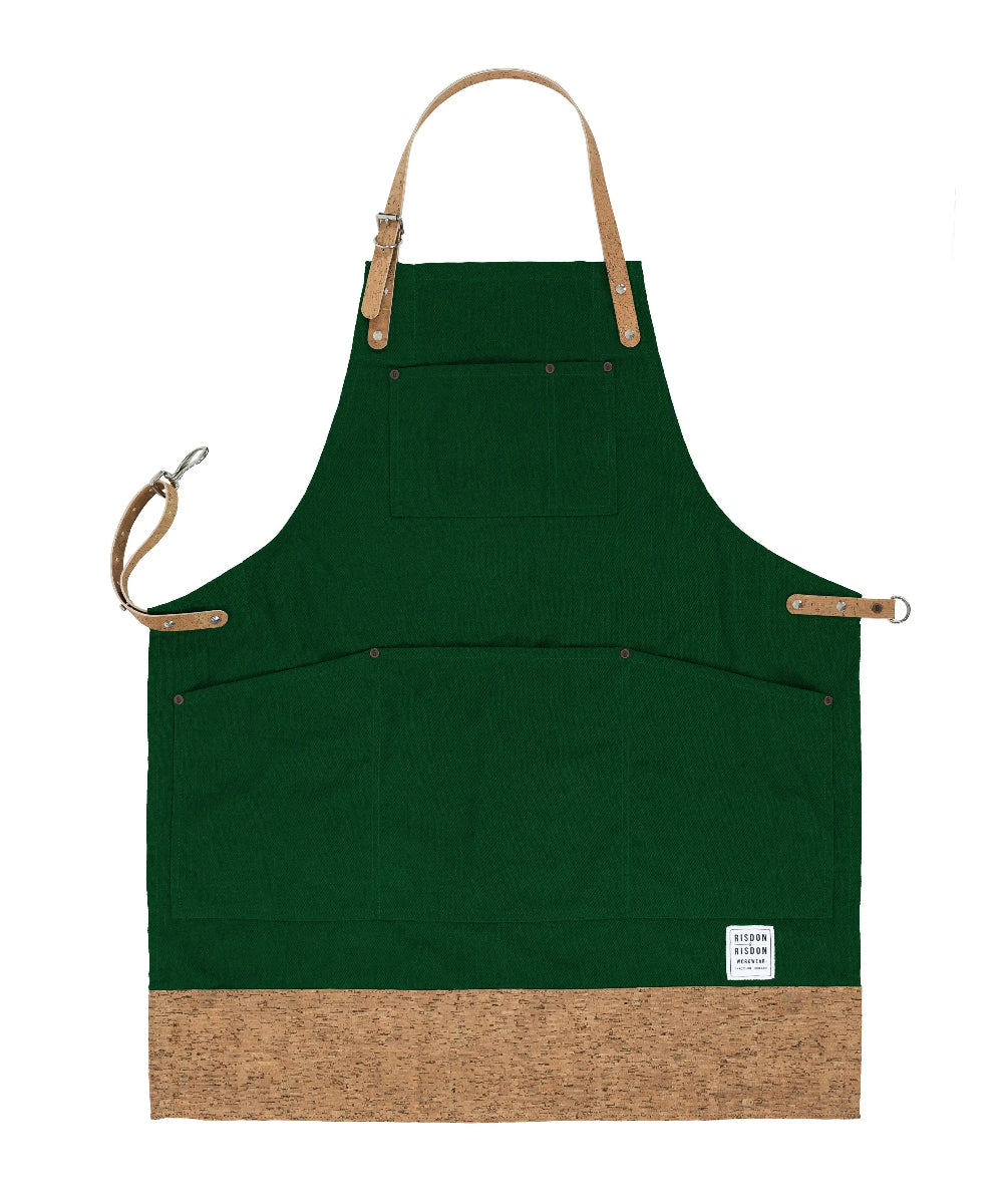 Green apron with cork-like bottom section and brown straps on a white background