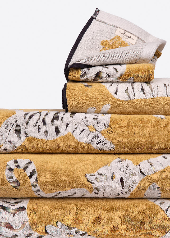 Stack of folded towels with tiger pattern on a white background