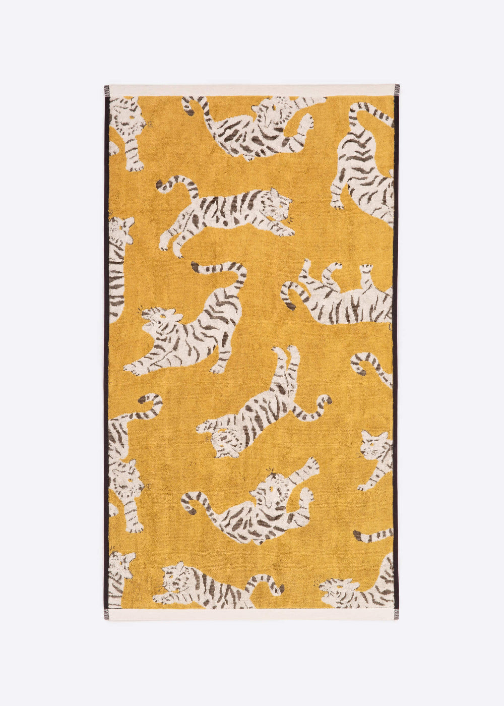 Yellow towel with white tiger pattern on a white background