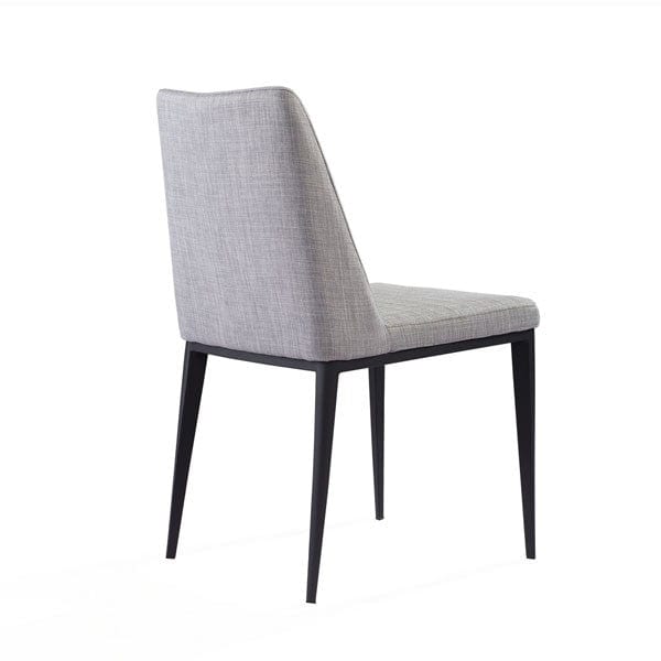 Tommy Franks Grey upholstered dining chair with black legs on a white background