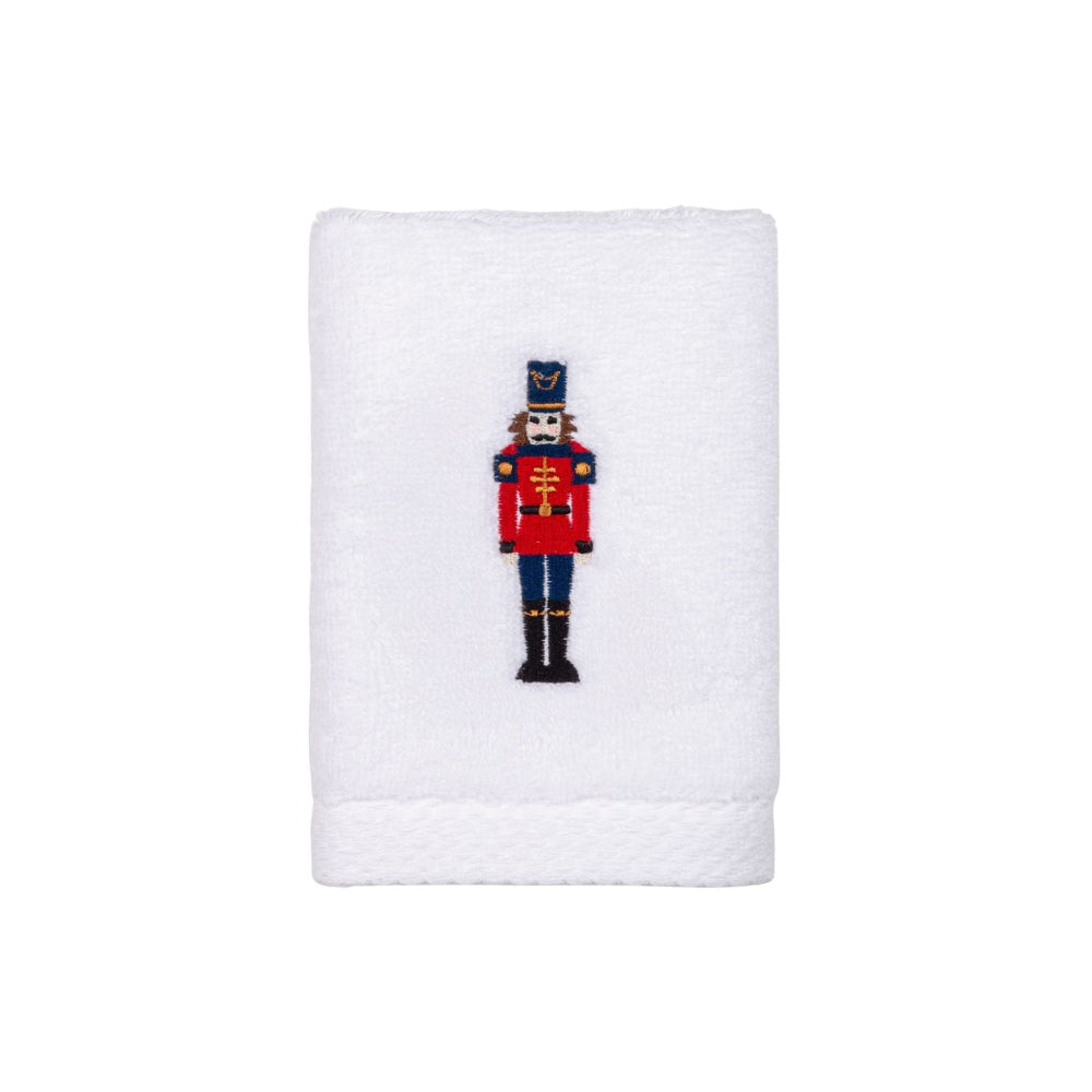 White towel with a embroidered nutcracker design on a white background