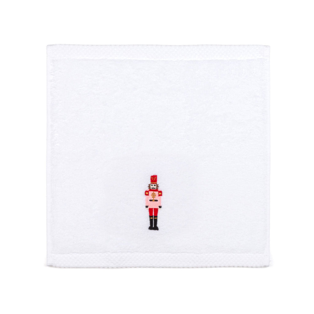 White face cloth towel with a red and black nutcracker design on a white background