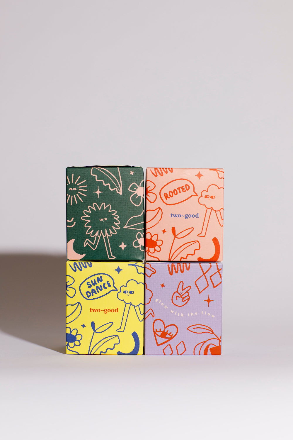 Four colourful boxes with abstract designs on a light grey background