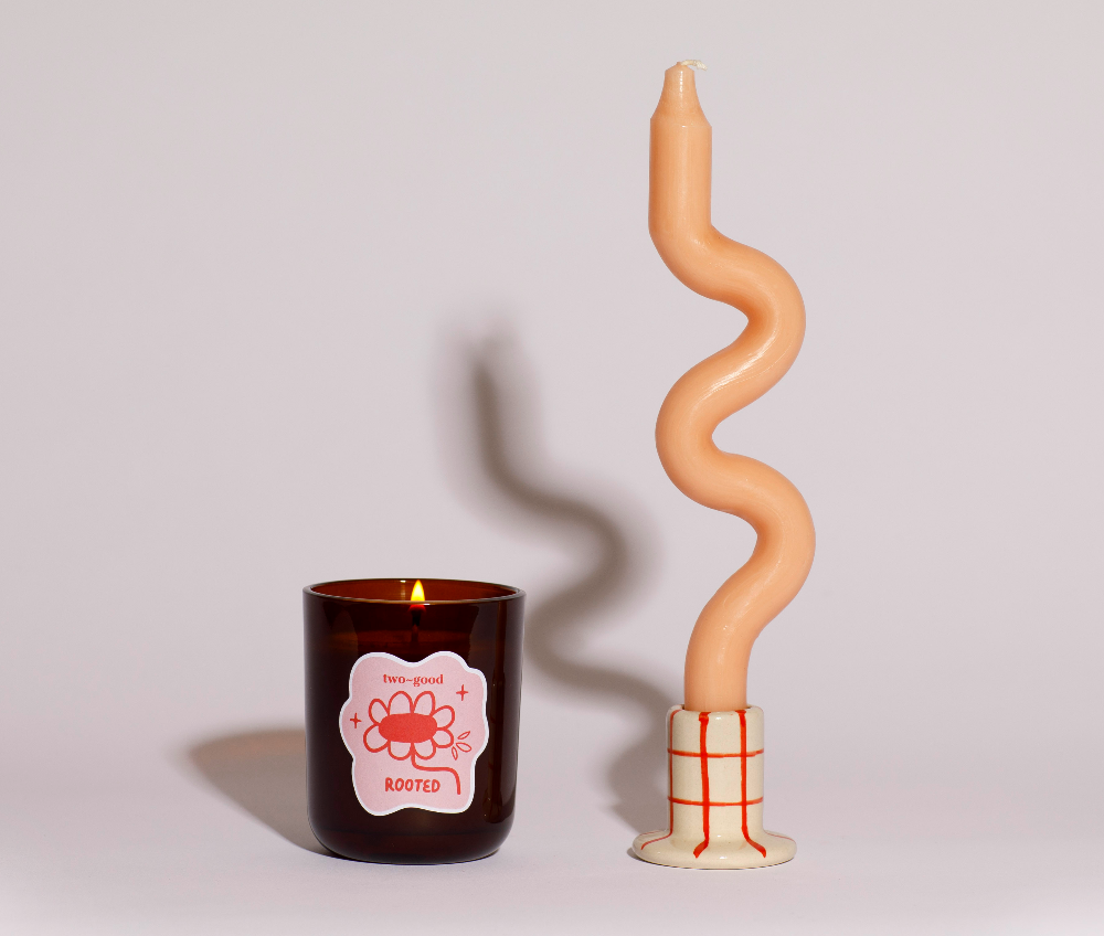 Candle with a spiral design on a plain background
