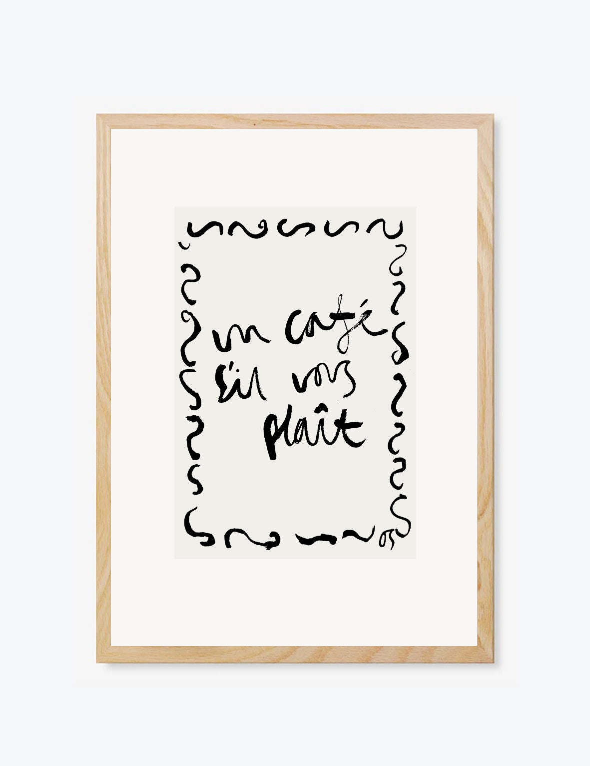 Framed artwork with black text 'un cafe sil vous plait' on a white background 