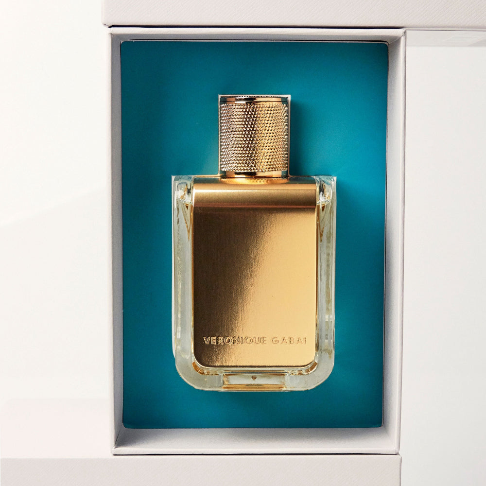 Gold veronique gabai perfume bottle in a blue box 