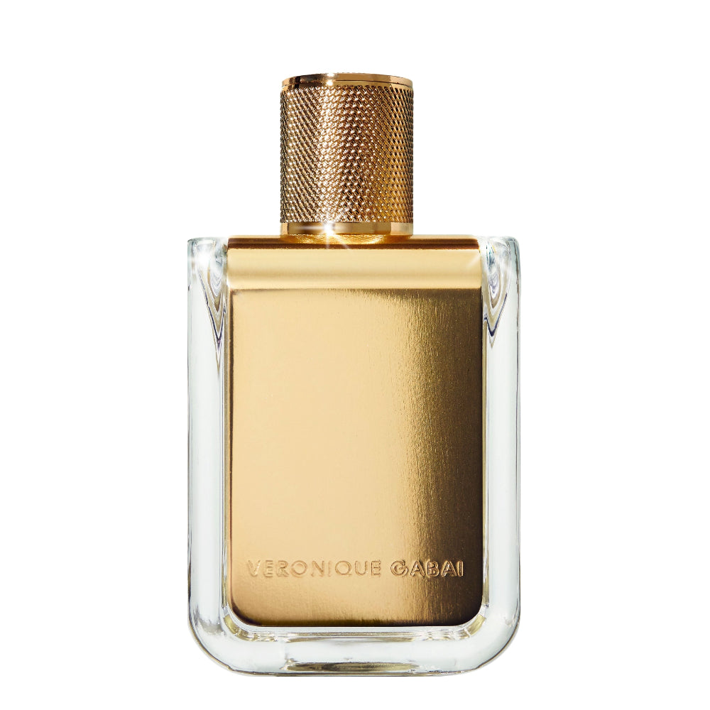 Gold perfume bottle with clear glass base on a white background