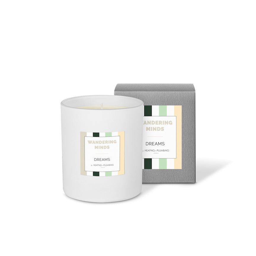 White candle with 'Wandering Minds' packaging on a white background