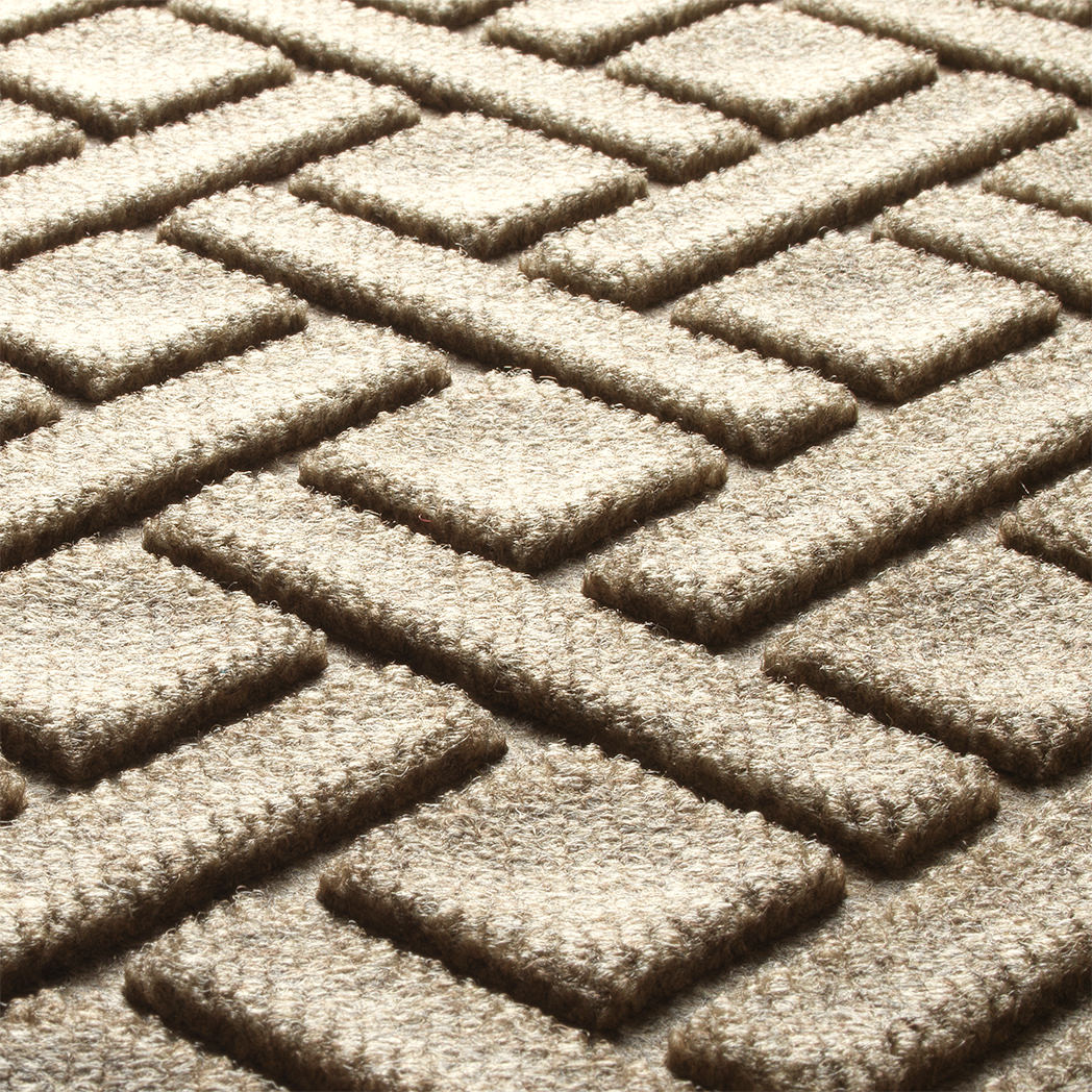 Close-up of the Camel WaterHog Lattice doormat showing raised geometric fibres and recessed dirt-trapping grooves.
