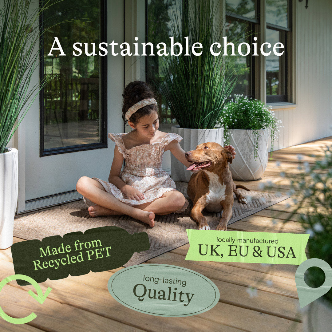 Child sitting beside a brown dog on a WaterHog mat outside a home, with information about recycled PET materials.