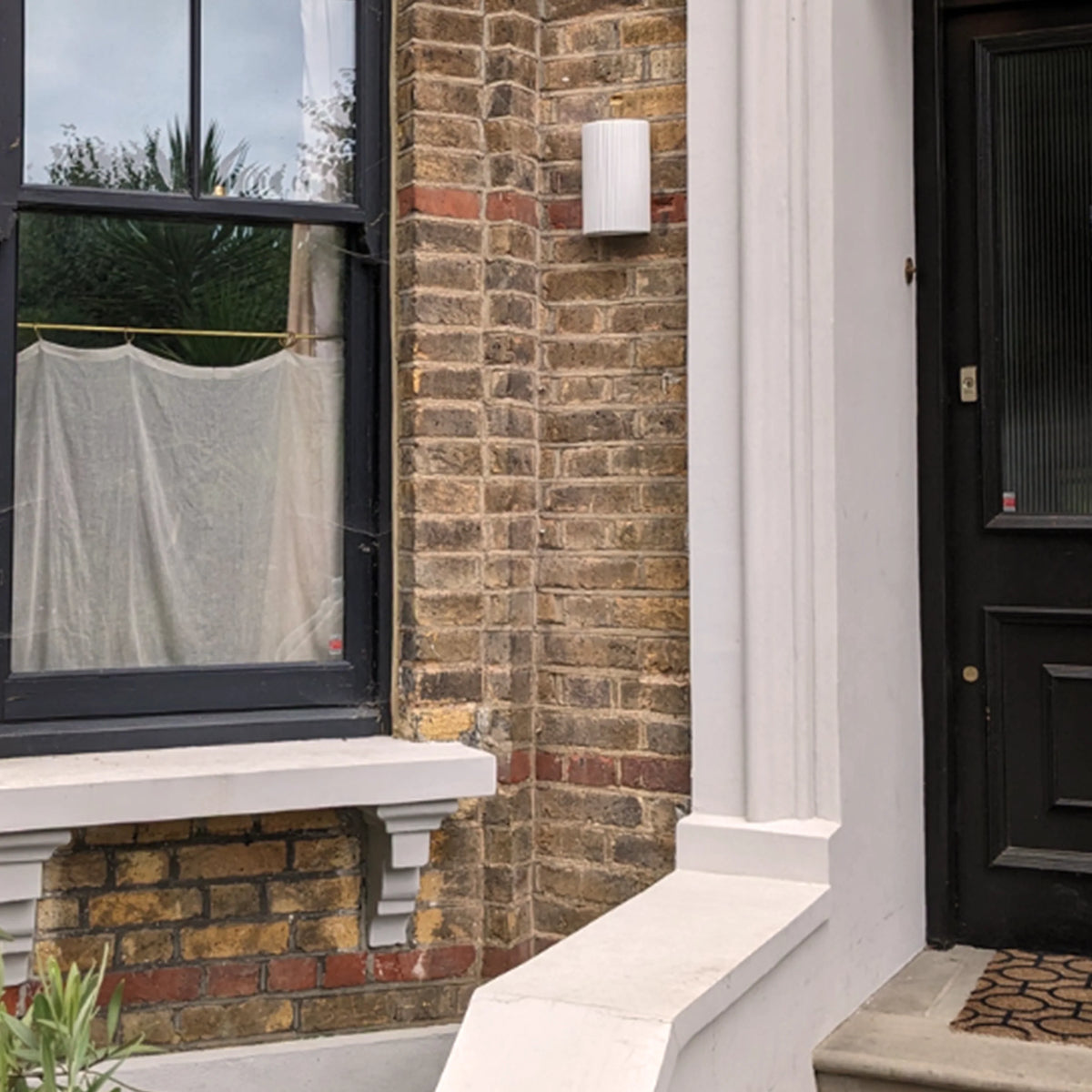 White ceramic IP44 wall light used outdoors