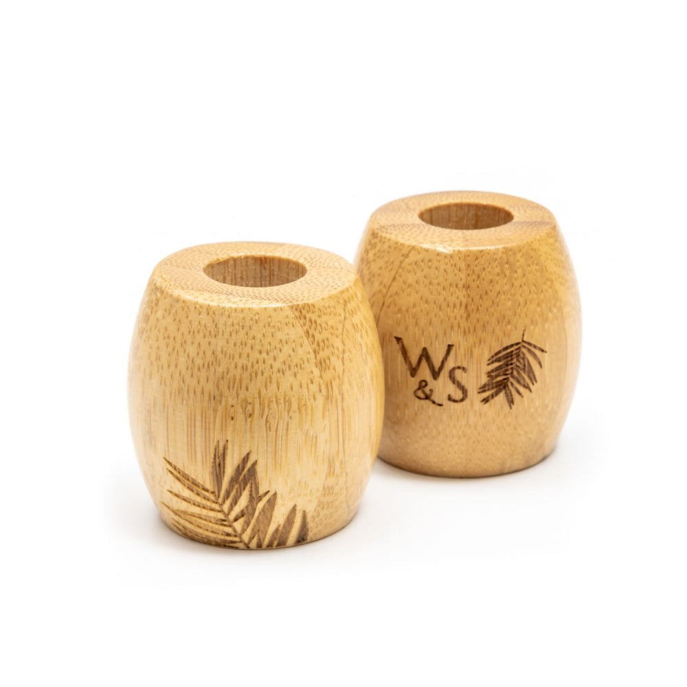 Two bamboo toothbrush holders with 'WS' engraving on a white background