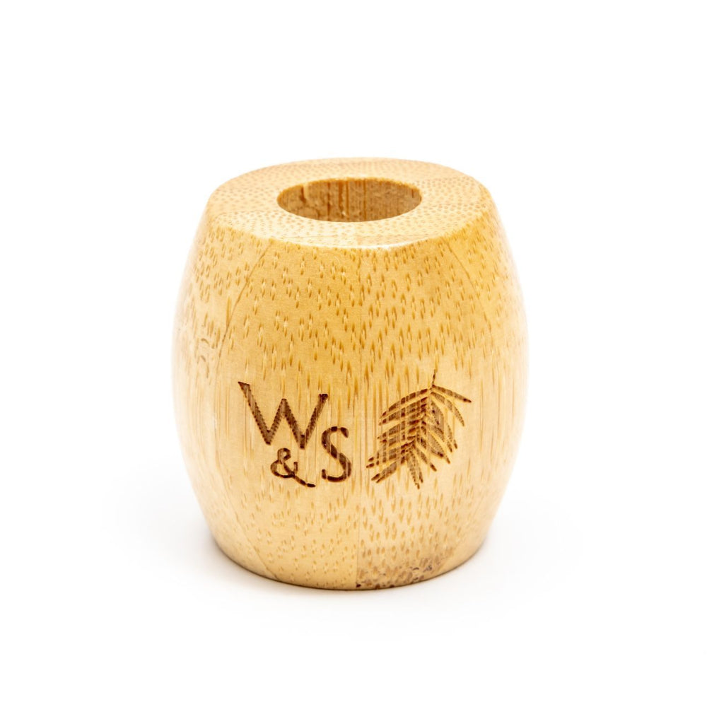 Wooden toothbrush holder with 'W&S' branding on a white background
