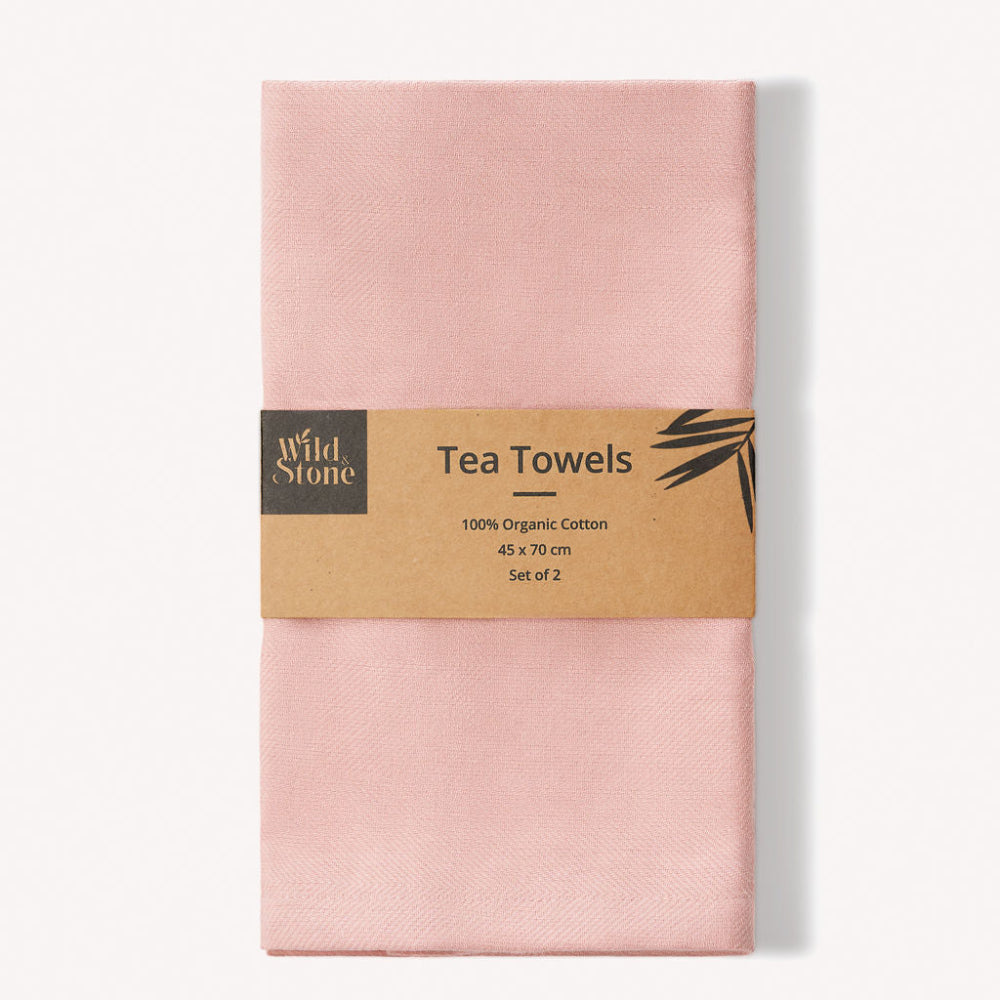 Pack of pink tea towels with a label on a white background