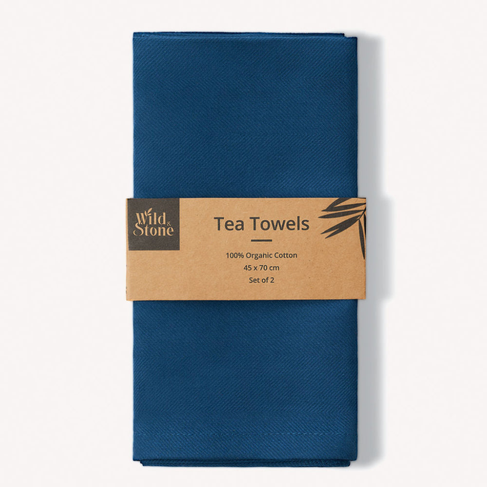 Set of two blue tea towels with a Wild Stone label on a white background