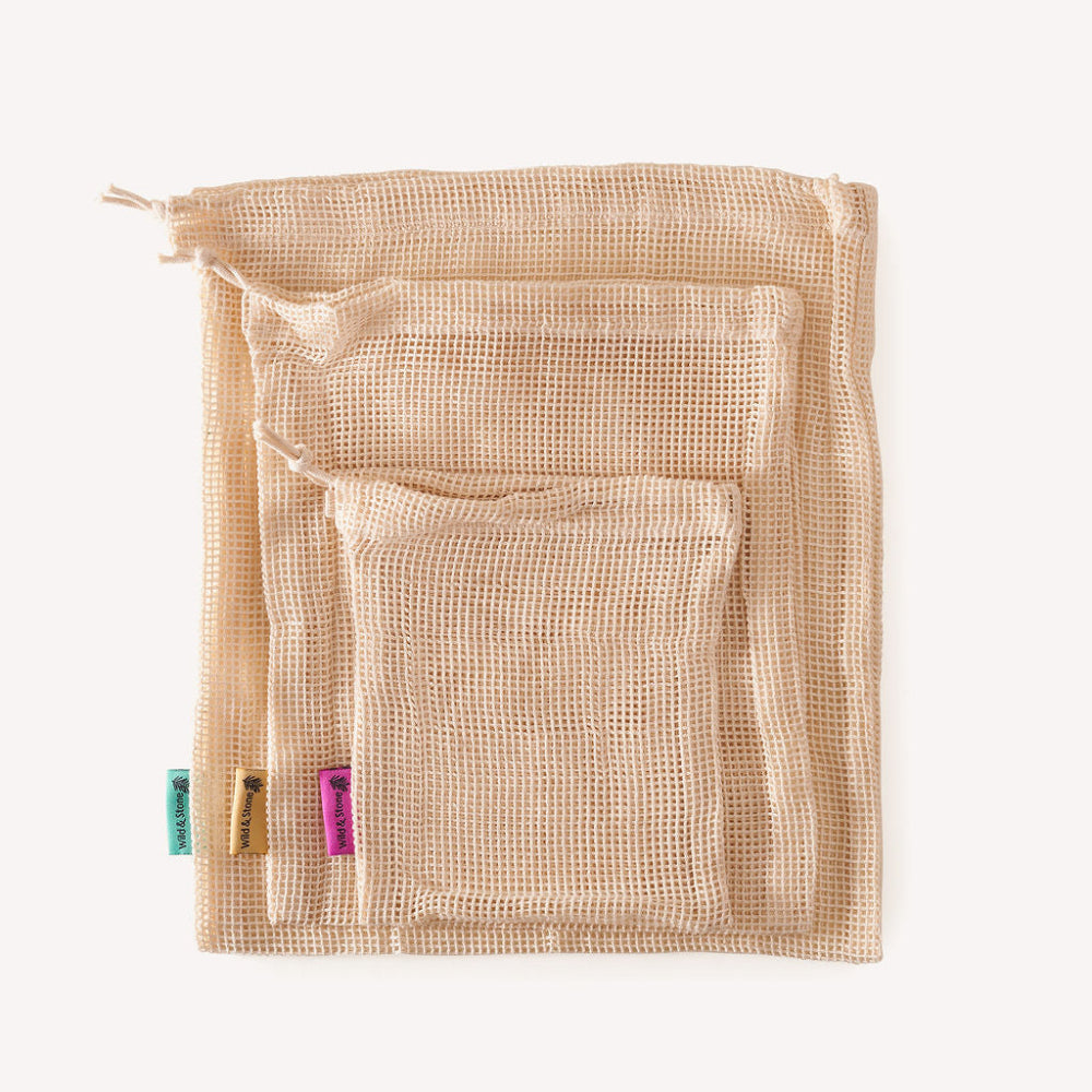 Beige mesh produce bags with a clear front pocket on a white background