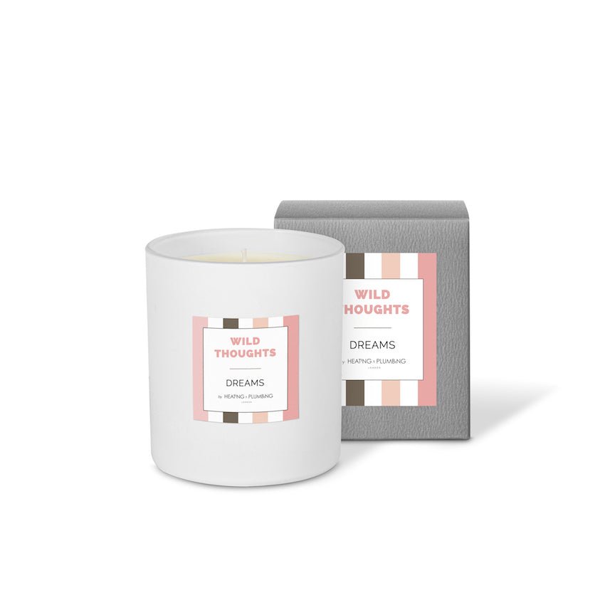White candle with 'Wild Thoughts' packaging on a white background