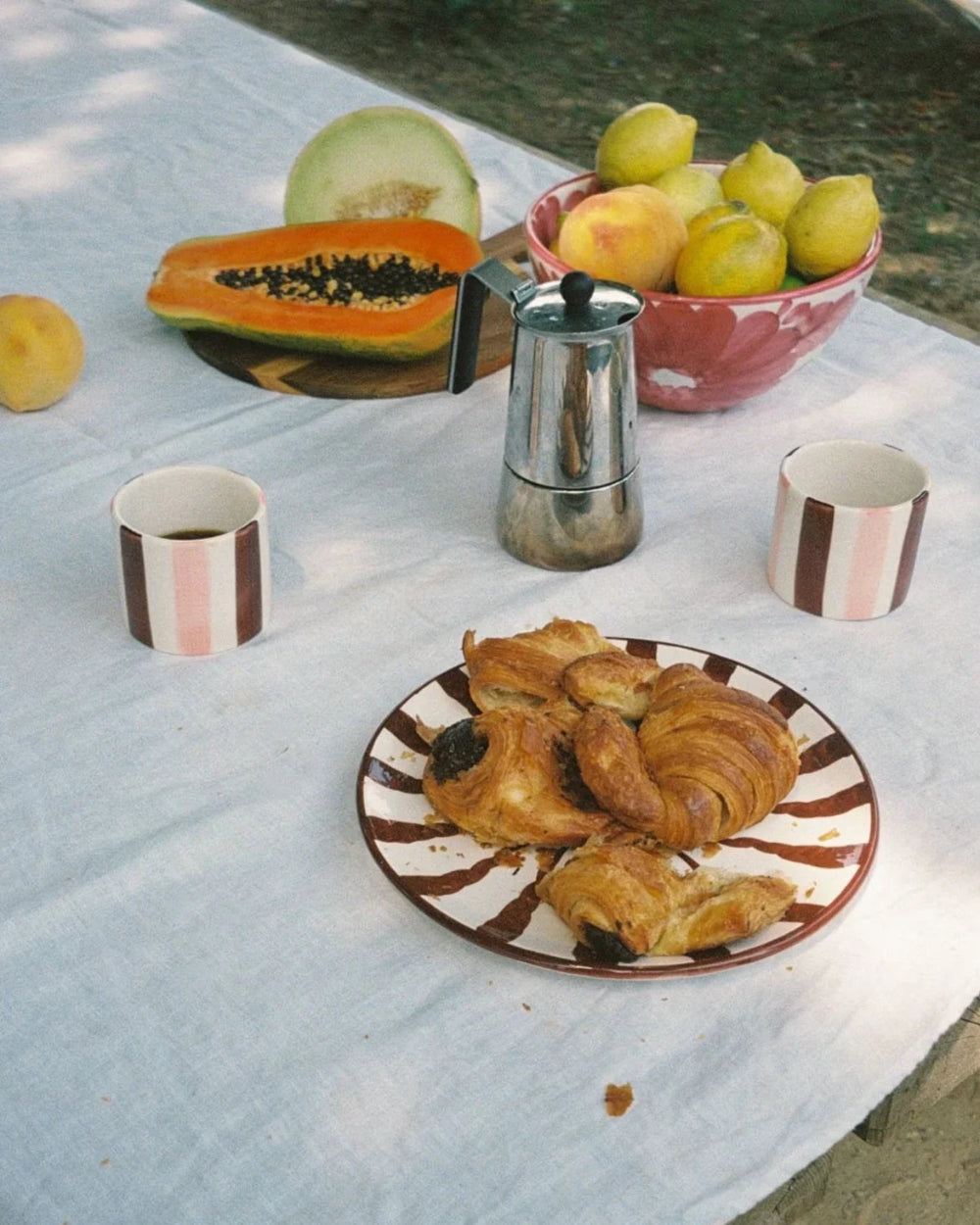 Espresso Wave ceramic plate with croissants on an outdoor breakfast table