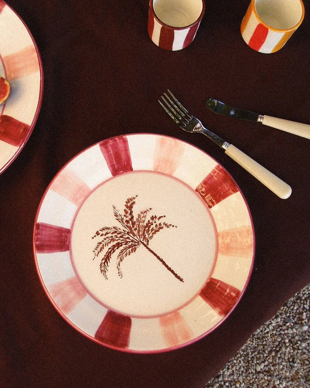 Two handmade ceramic serving plates featuring Woven Rosa's decorative palm motif
