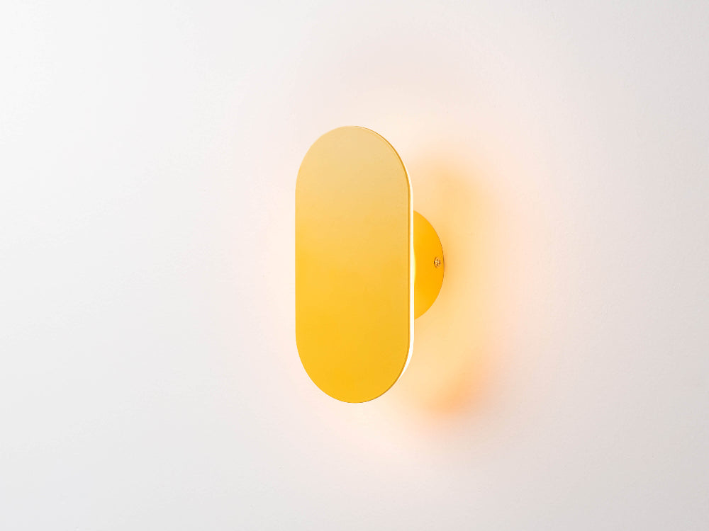 Close-up of yellow metal mini diffuser wall light